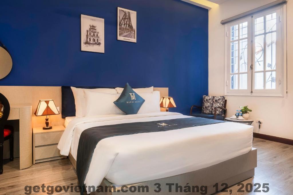 Phòng khách sạn Hanoi Bliss Hotel phong cách hiện đại, trang nhã, giường lớn, sàn gỗ, ánh sáng đẹp