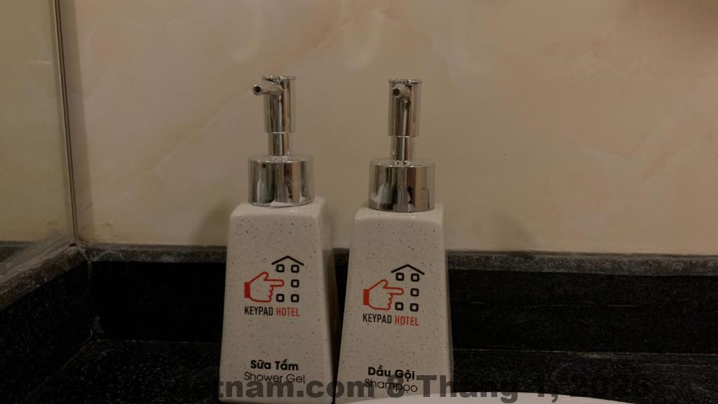 Phòng ngủ Keypad Hotel diện tích vừa phải, nội thất gỗ tối màu, thiết kế đơn giản