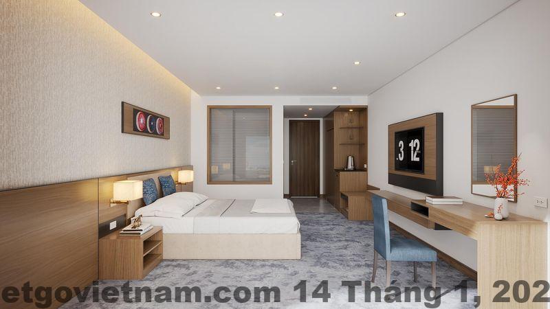 Phòng Deluxe King tại Mường Thanh Luxury Điện Biên với giường lớn và nội thất gỗ truyền thống